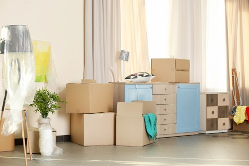 Removal team preparing furniture with protective materials for a safe move