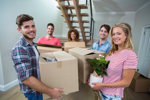 Removal team loading household boxes and furniture into a moving van